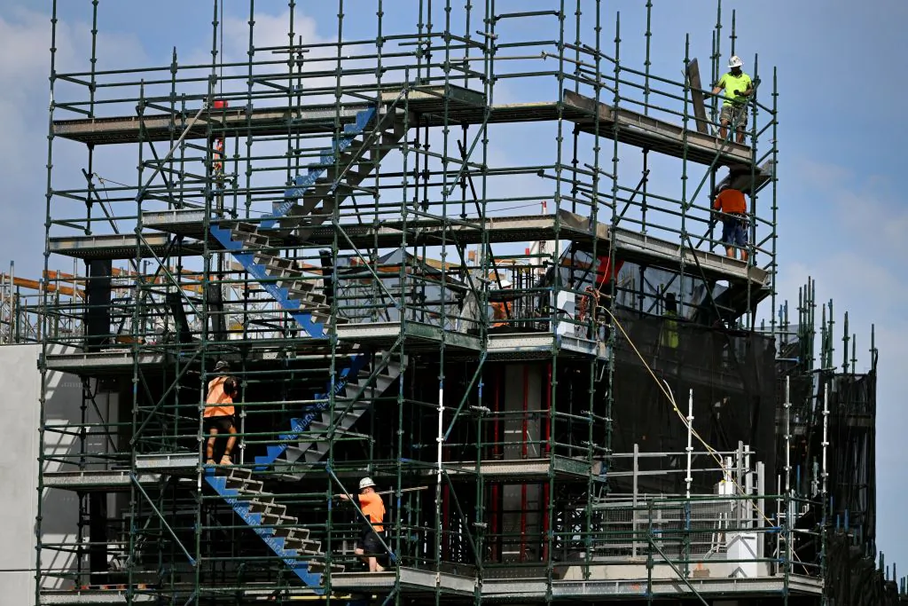 Men work on a construction site, building new apartments in Melbourne on April 4, 2023. (William WEST / AFP via Getty Images)