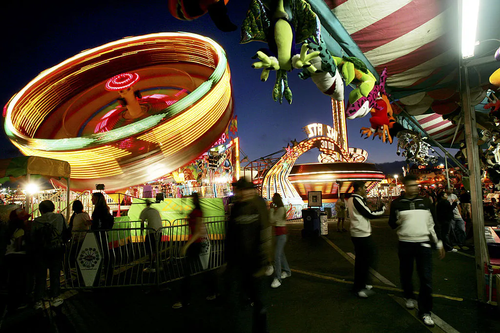 Fair-goers enjoy rides and games at dusk during the San Diego County Fair in Del Mar, Calif., on June 29, 2005. (Sandy Huffaker/Getty Images)
