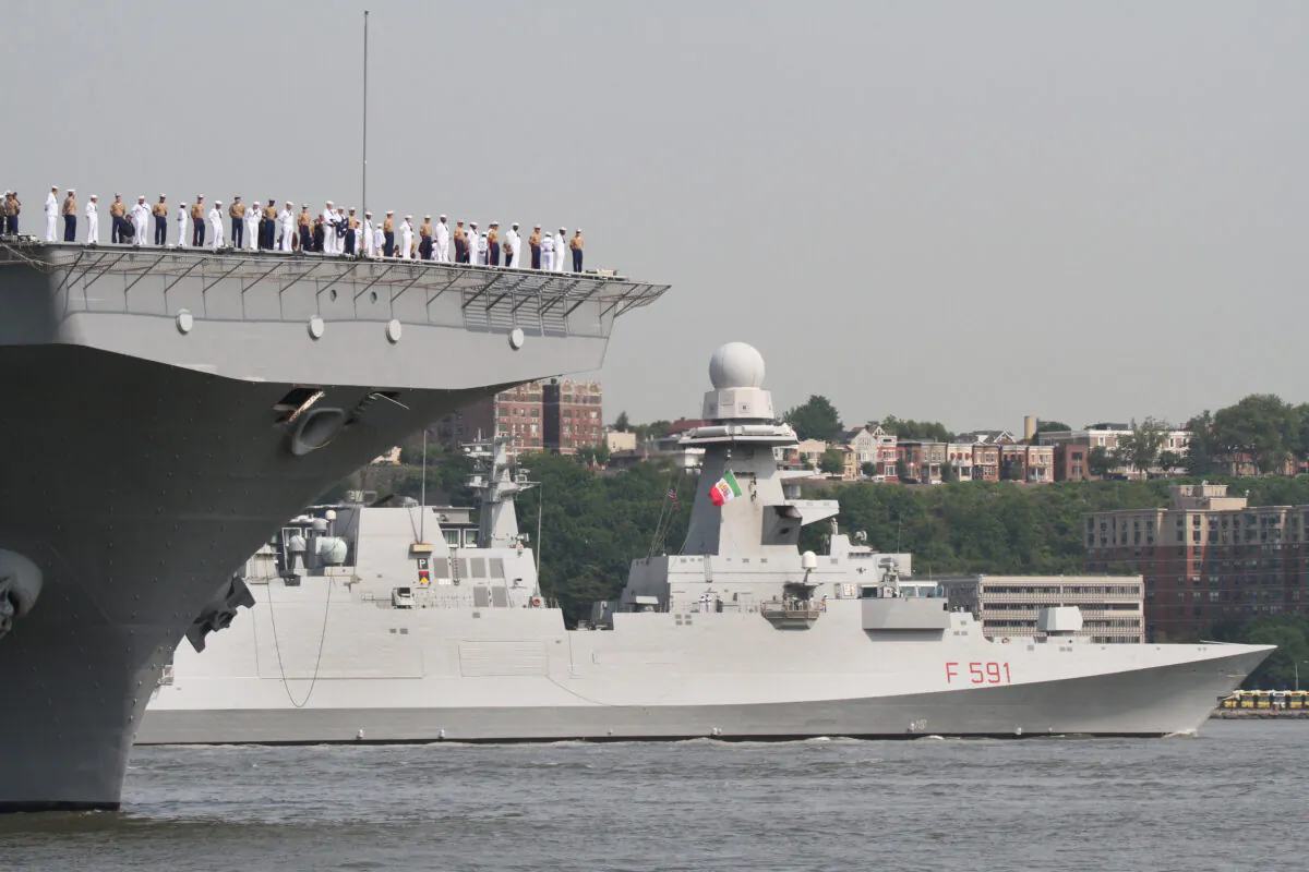 The Italian Bergamini-class frigate Virginio Fasan emerges from behind the USS Wasp on the Hudson River in New York on May 24, 2023. (Richard Moore/The Epoch Times)