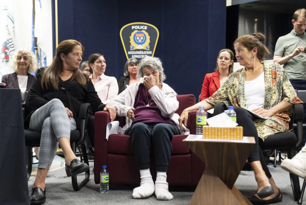Yvonne Prior, centre, reacts with her daughters Moreen, left and Doreen during a press conference as police confirm the identity of the killer in the 1975 murder of her daughter Sharron on May 23, 2023 in Longueuil, Que. (The Canadian Press/Christinne Muschi)