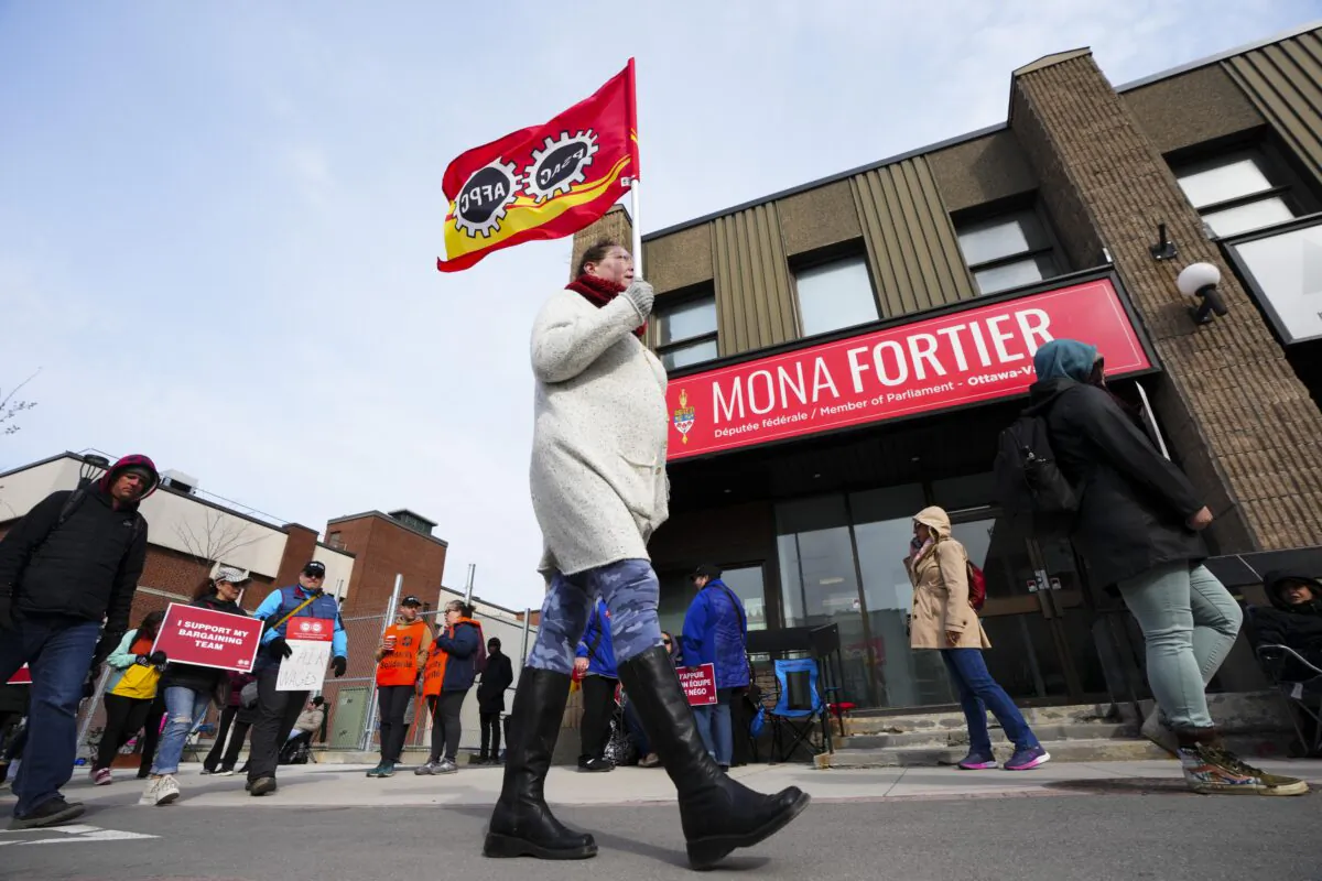 PSAC workers and supporters picket in front of President of the Treasury Board Mona Fortier's office in Ottawa on April 21, 2023. (Sean Kilpatrick/The Canadian Press)