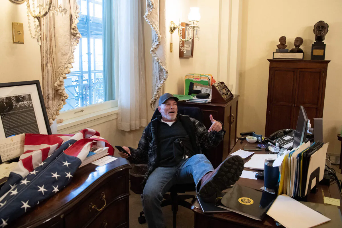 Richard "Bigo" Barnett sits inside the office of Speaker of the House Nancy Pelosi as he protests at the U.S. Capitol on Jan. 6, 2021. (Saul Loeb/AFP via Getty Images)