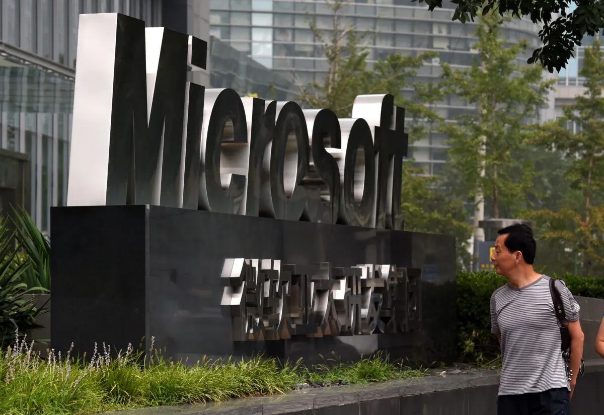 A man walks past a Microsoft sign outside a Microsoft office building in Beijing on July 31, 2014. (Greg Baker/AFP via Getty Images)