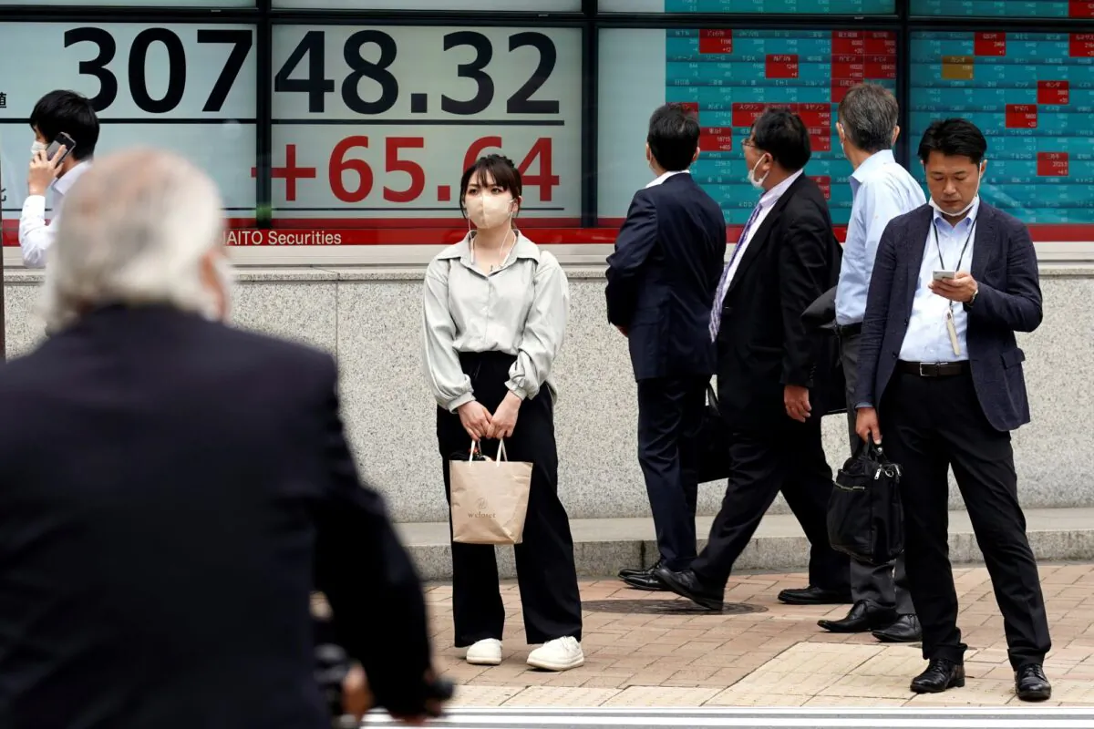 Some people watch at an electronic stock board showing Japan's Nikkei 225 index at a securities firm, in Tokyo on May 25, 2023. (Eugene Hoshiko/AP Photo)