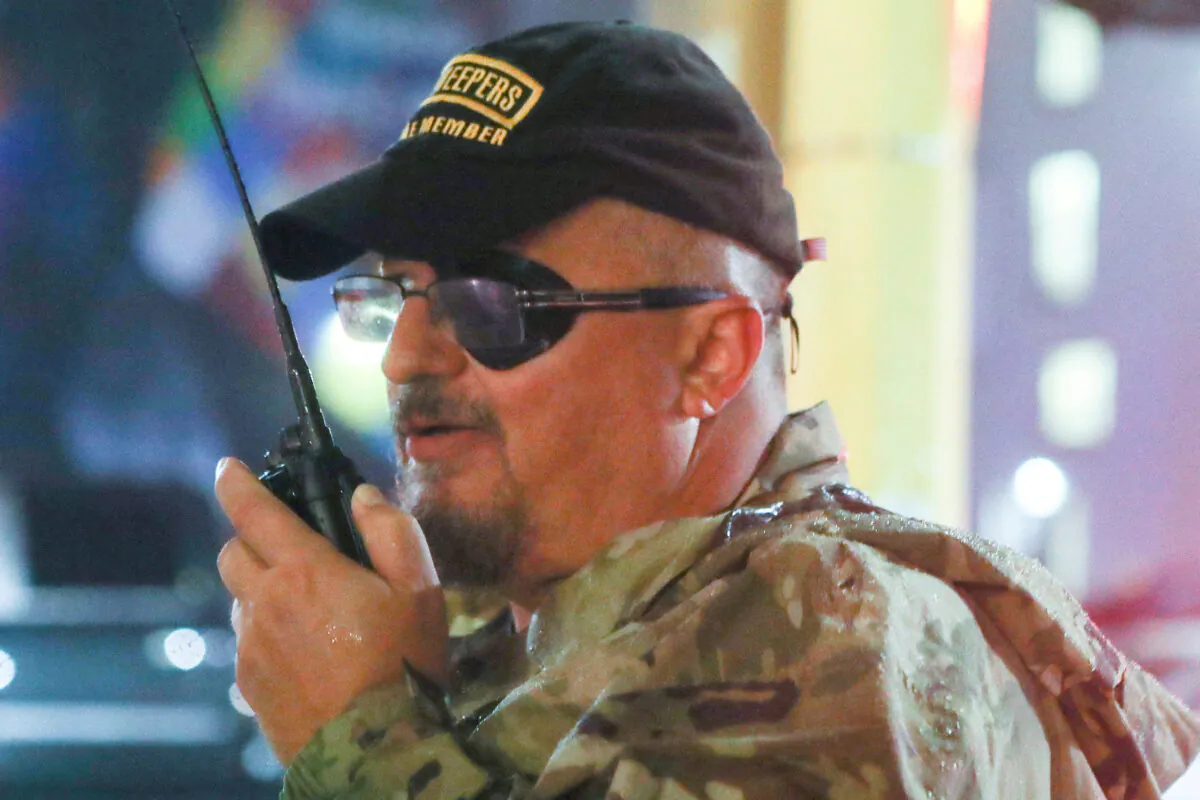 Oath Keepers founder Stewart Rhodes uses a radio as he departs with volunteers from a rally held by U.S. President Donald Trump in Minneapolis on Oct. 10, 2019. (Jim Urquhart/Reuters)