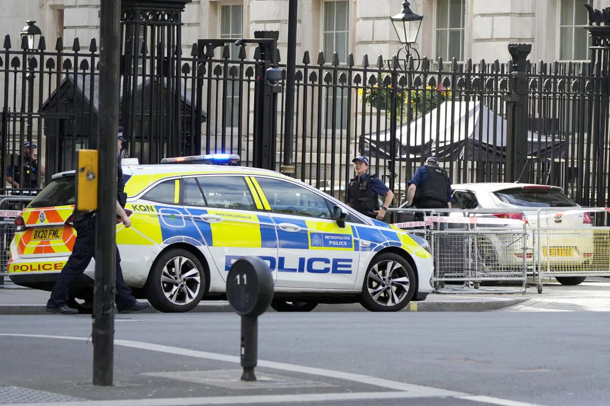Police at the scene after a car collided with the gates of Downing Street in London on May 25, 2023. (Alastair Grant/AP Photo)