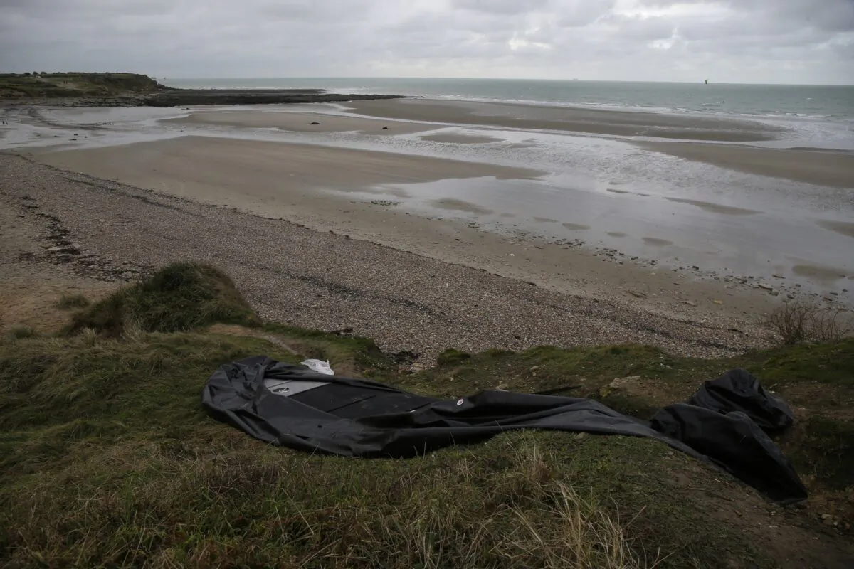 A damaged inflatable small boat on the shore in Wimereux, Calais, northern France, on Nov. 25, 2021. (Michel Spingler/AP Photo)