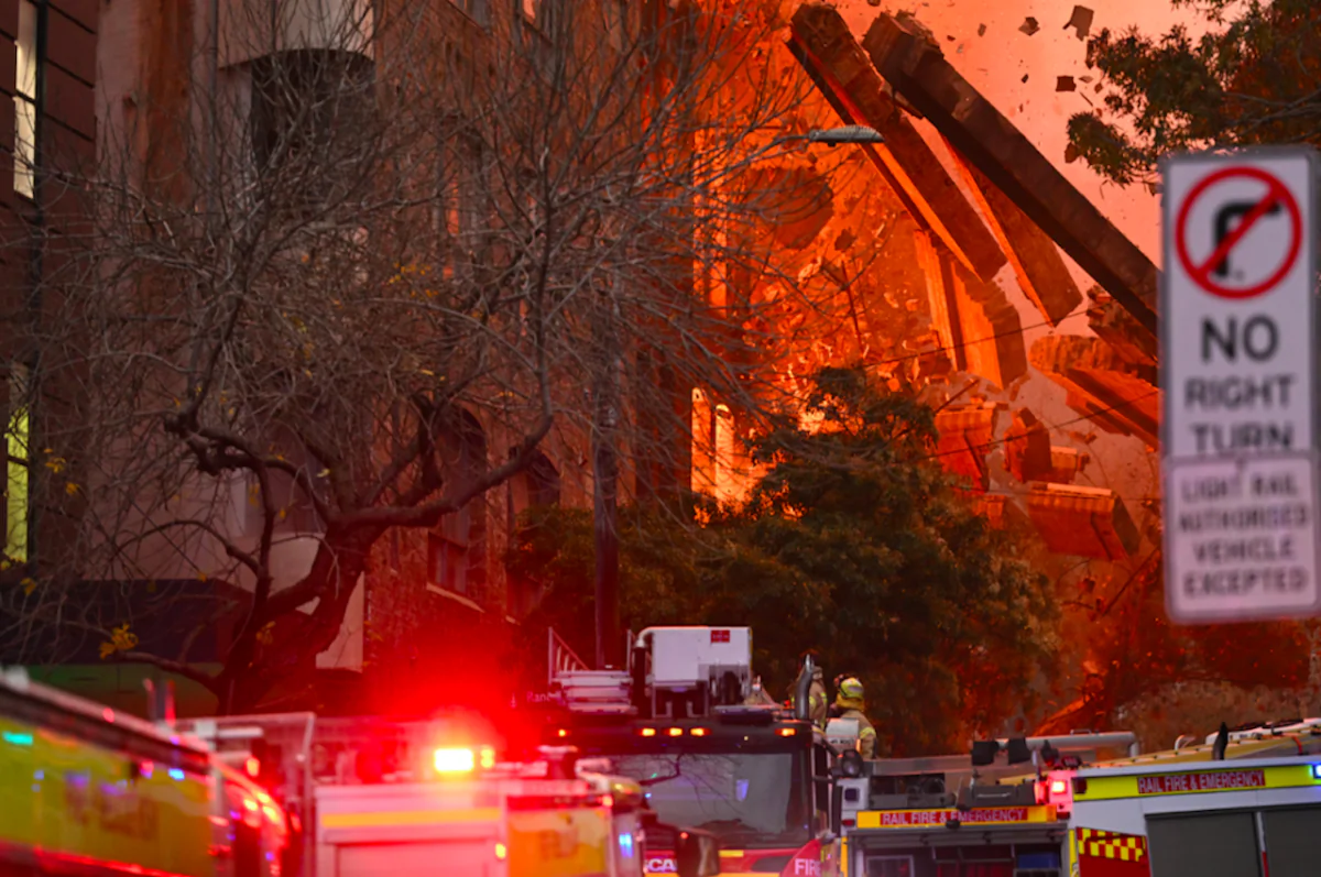 A wall collapses during a building fire in the Central Business District of Sydney, Australia on May 25, 2023. (AAP Image/Dean Lewins)