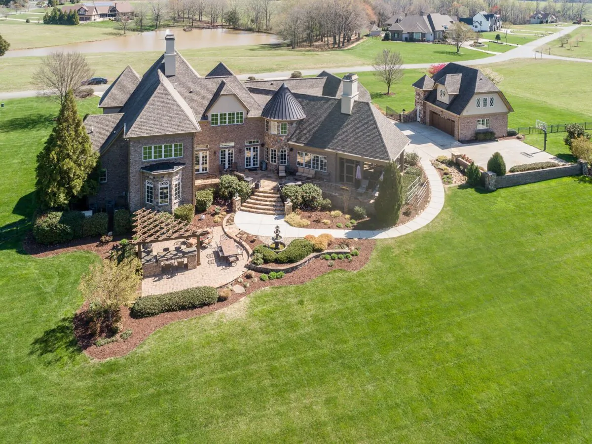 The rear of this estate is designed to enjoy the beautiful setting, with an outdoor kitchen and dining area looking out over the vast yard. (Charlotte Virtual Home Tours/Premier Sotheby’s International Realty)