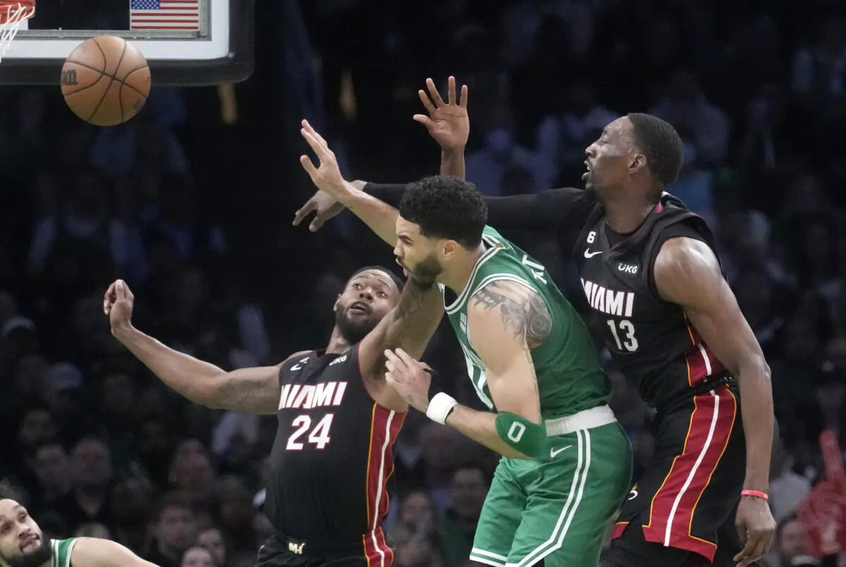 Miami Heat forward Haywood Highsmith (24) and center Bam Adebayo (13) go after a rebound along with Boston Celtics forward Jayson Tatum during the first half in Game 5 of the NBA basketball Eastern Conference Final series in Boston on May 25, 2023,. (Charles Krupa/AP Photo)