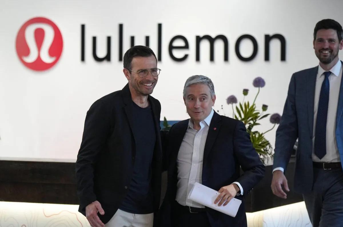 Lululemon CEO Calvin McDonald, left, Minister of Innovation, Science and Industry, Francois-Philippe Champagne, centre, and Minister of Immigration, Refugees and Citizenship Sean Fraser arrive for a news conference at the company's headquarters, in Vancouver, on May 25, 2023. (The Canadian Press/Darryl Dyck)
