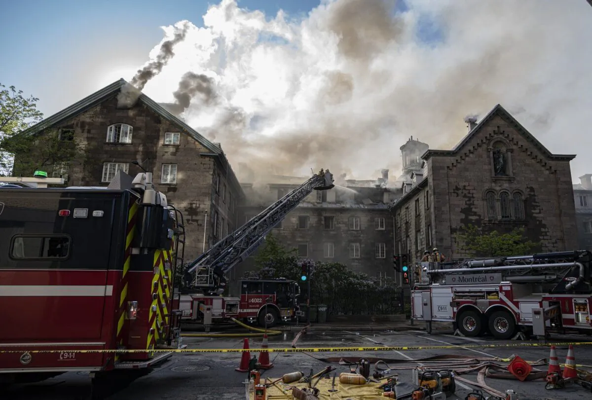 Firefighters respond to a five-alarm fire at the former Monastere du Bon Pasteur, a 19th century heritage building on May 26, 2023 in Montreal. (The Canadian Press/Christinne Muschi)
