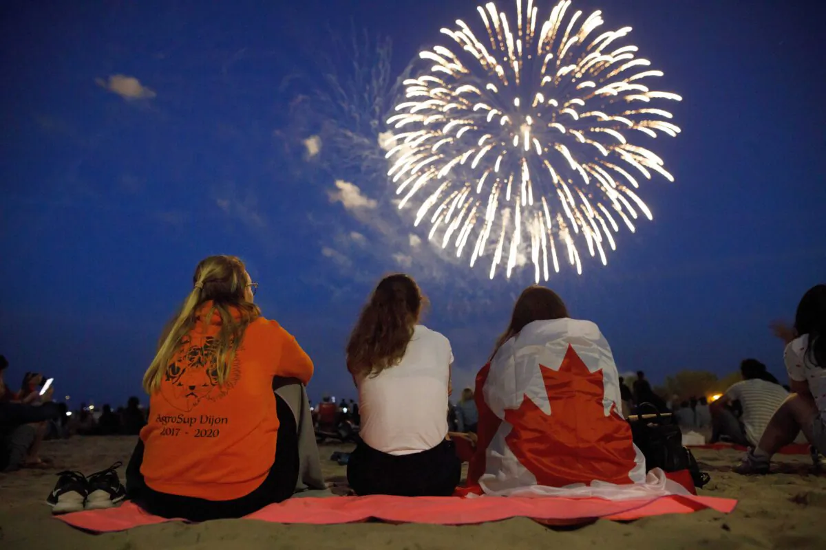 People watch a fireworks display at Ashbridges Bay during Canada Day festivities in Toronto on July 1, 2019. (Cole Burston/Getty Images)