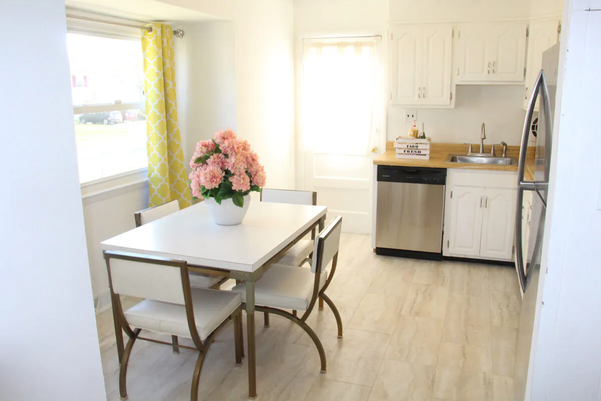 A kitchen is upgraded by painting wood cabinets and peel and stick floor tiles. (Handout/TNS)