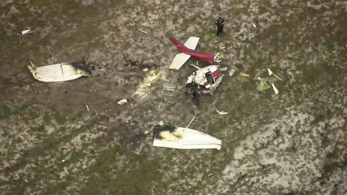 Emergency responders at the scene of a plane crash at Palm Beach County Park Airport near Lantana, Fla., on May 26, 2023. (WPTV via AP)