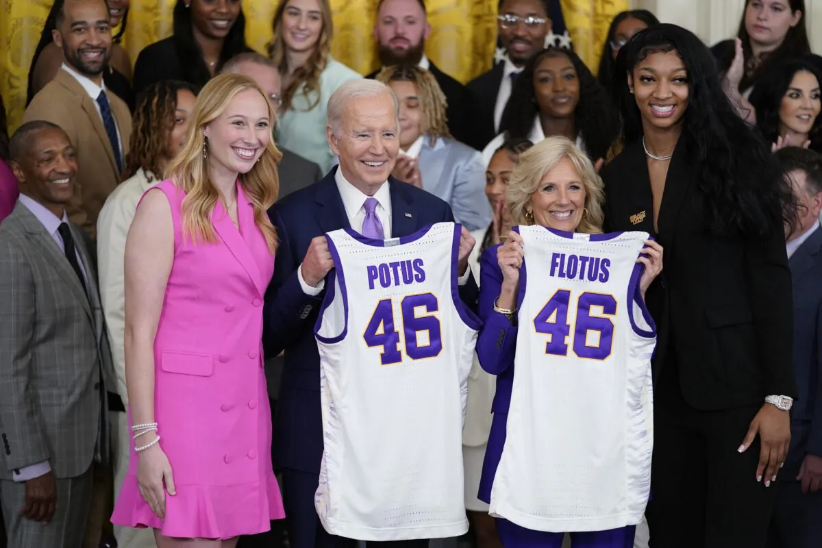 President Joe Biden and First Lady Jill Biden are presented with jerseys by LSU women's basketball team captains Angel Reese (R) and Emily Ward (L) during an event to honor the 2023 NCAA national championship team in the East Room of the White House on May 26, 2023. (Evan Vucci/AP Photo)