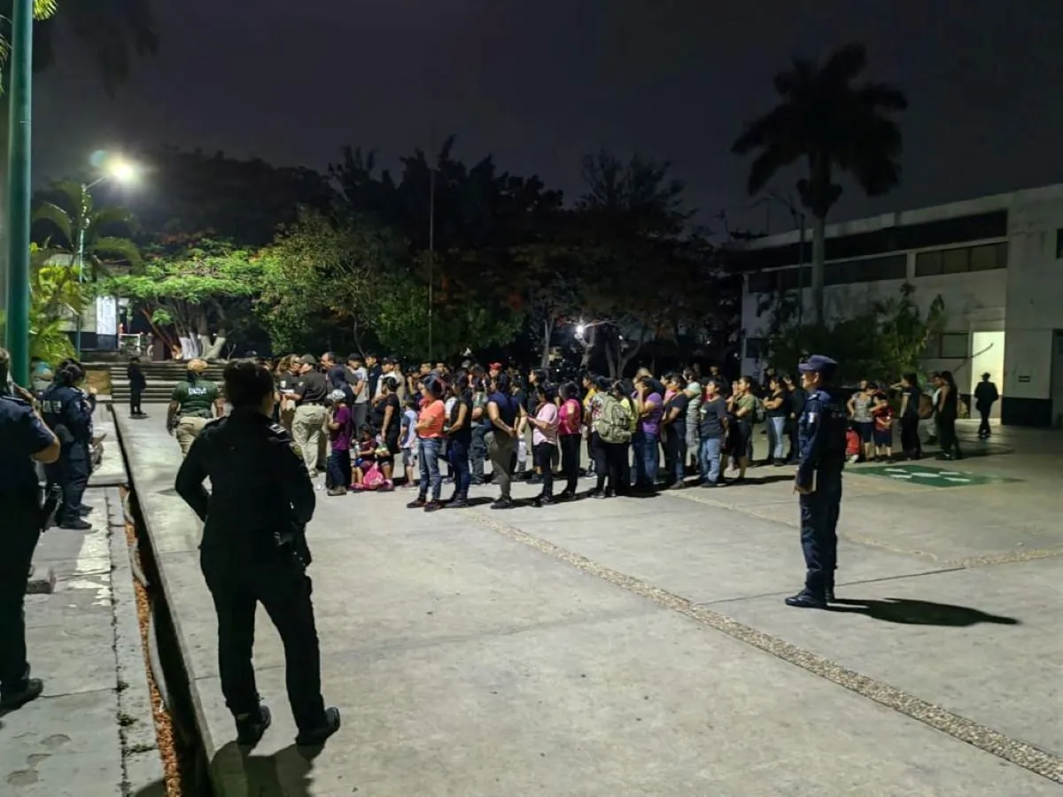 Members of the National Institute of Migration (INM) and police officer are monitoring close to migrants after finding 175 migrants crowded into a truck trailer in the southern state of Chiapas, Mexico, in this photo released on May 26, 2023. (INM/Handout via Reuters)