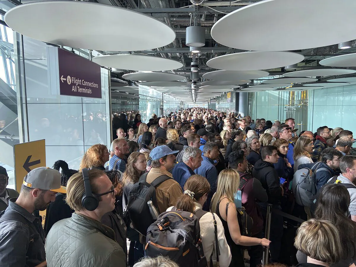 People queue at arrivals at Heathrow airport in London, on May 27, 2023. (Ivan Coninx via AP)