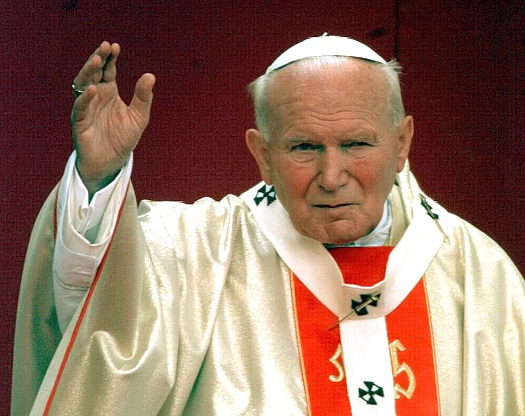 Pope John Paul II waves the faithful in Vercelli, May 23, 1998, during beatification ceremonies for Italian army chaplain Secondo Pollo, who died in 1941. (Gerard Julien/AFP via Getty Images)