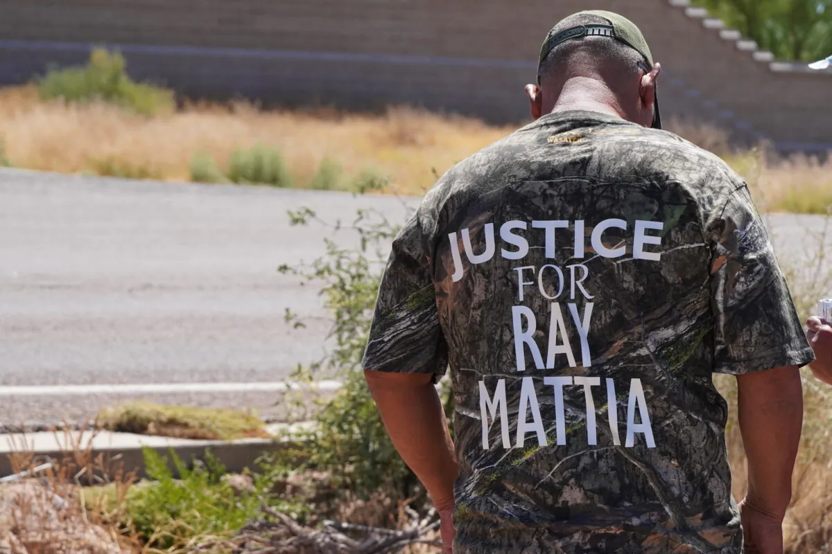 A man wears a "Justice For Ray Mattia" camouflage shirt during a rally outside of the  U.S. Customs and Border Patrol station in Why, Ariz., on May 27, 2023. (Allan Stein/The Epoch Times)