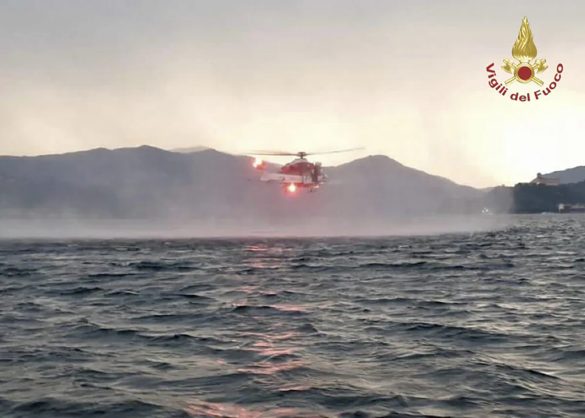 A helicopter searches for missing after a tourist boat capsized in a storm on Italy's Lago Maggiore in the northern Lombardy region on May 28, 2023. (Vigili Del Fuoco via AP)