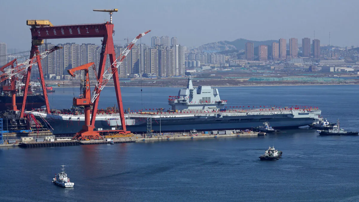 Type 001A, China's second aircraft carrier, is transferred from the dry dock into the water during a launch ceremony at Dalian shipyard in Dalian, northeast China's Liaoning Province, April 26, 2017. (STR/AFP via Getty Images)