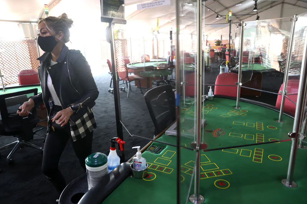 A worker sets up gaming tables in an outdoor setting at Artichoke Joe's Casino in San Bruno, Calif., on Sept.4, 2020. (Justin Sullivan/Getty Images)