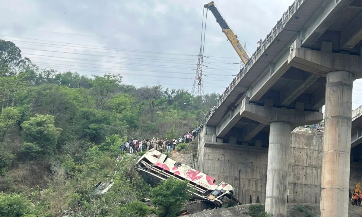 Rescuers prepare to use a crane after a bus carrying Hindu pilgrims to a shrine skid off a highway bridge into a Himalayan gorge near Jammu, India, on May 30, 2023. (Channi Anand/AP Photo)