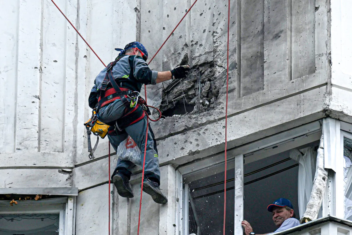 A specialist inspects the damaged facade of a multi-storey apartment building after a reported drone attack in Moscow on May 30, 2023. (Kirill  Kudryavtsev/AFP via Getty Images)