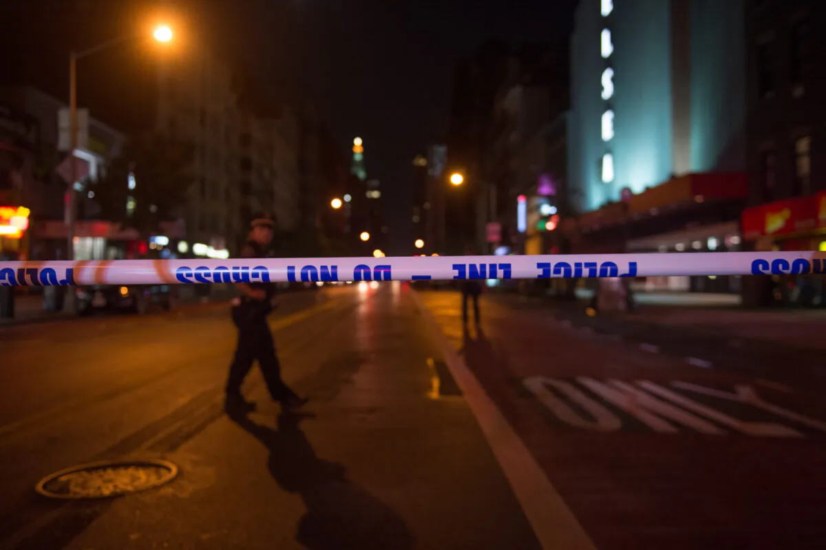 Police walk past police tape on a blocked off road near the site of an alleged bomb explosion on West 23rd Street in New York on Sept. 17, 2016. (Bryan R. Smith/AFP via Getty Images)