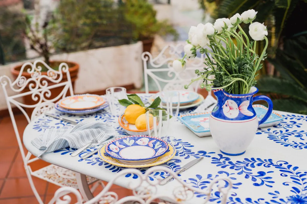 An al fresco table set with plates from VIETRI's Solimene Campagna di Vietri sul Mare collection. The dishes are handmade and painted in the town of Vietri sul Mare on Italy’s Amalfi Coast. (Infraordinario Photo)