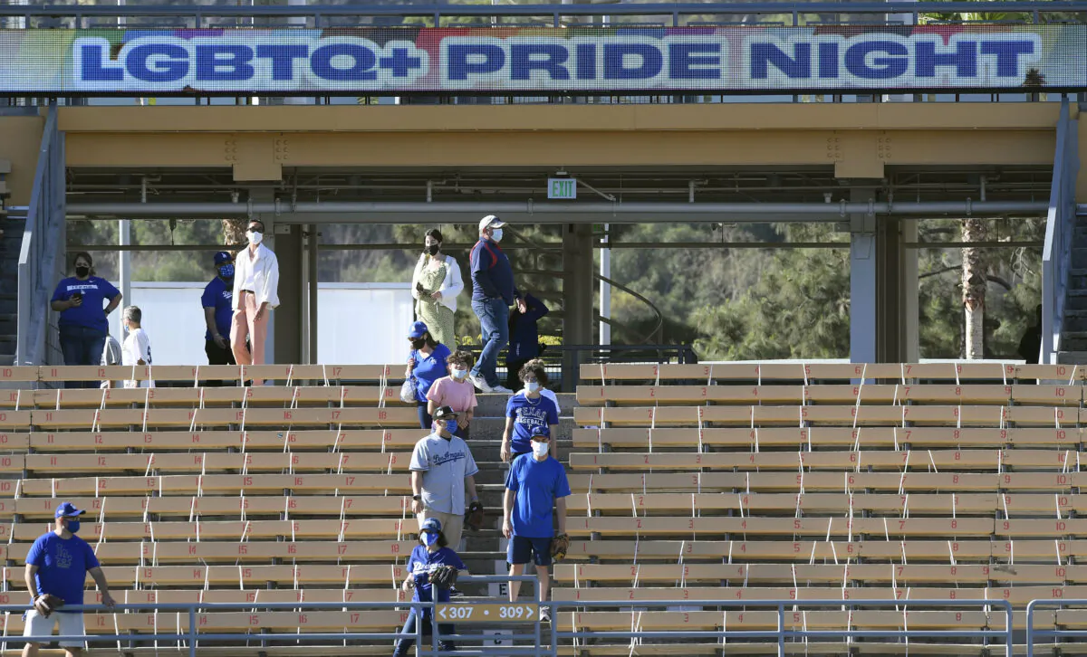 Fans watch batting practice prior to the start of a game between the Los Angeles Dodgers and Texas Rangers during the eighth annual LGBTQ+ Pride Night at Dodger Stadium in Los Angeles on June 11, 2021. (Kevork Djansezian/Getty Images)