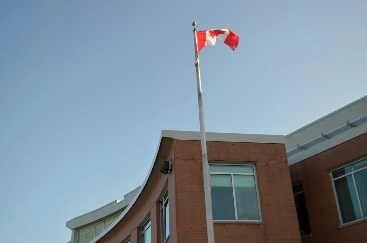 A Canadian flag flies outside York Catholic District School Board headquarters in Aurora, Ont., on May 29, 2023, when the board voted not to fly the pride flag. (Tara MacIsaac/The Epoch Times)