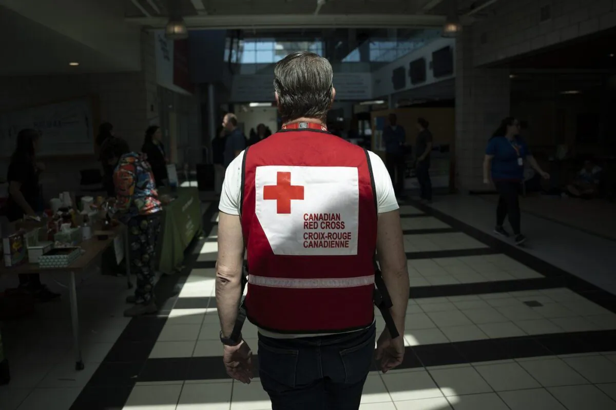 A representative from the Canadian Red Cross works at an evacuation centre where food and shelter is being provided for those forced from their homes due to the wildfire burning in suburban Halifax on May 30, 2023. (The Canadian Press/Darren Calabrese)

