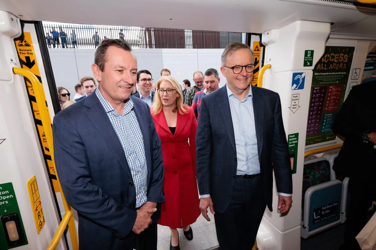 Prime Minister Anthony Albanese, retiring WA Premier Mark McGowan and Transport Minister Rita Saffioti board the first train during the opening of the METRONET Airport Line at High Wycombe Train Station in Perth, Australia on Oct. 8, 2022. (AAP Image/Richard Wainwright)