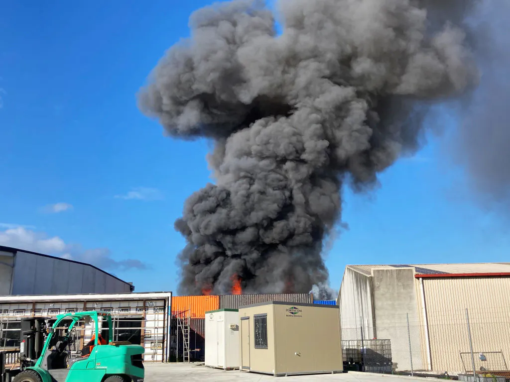 Plumes of black smoke rises over Papakura as a fire takes hold in a scrap metal yard in Auckland, New Zealand, on Jan. 13, 2021. (Phil Walter/Getty Images)