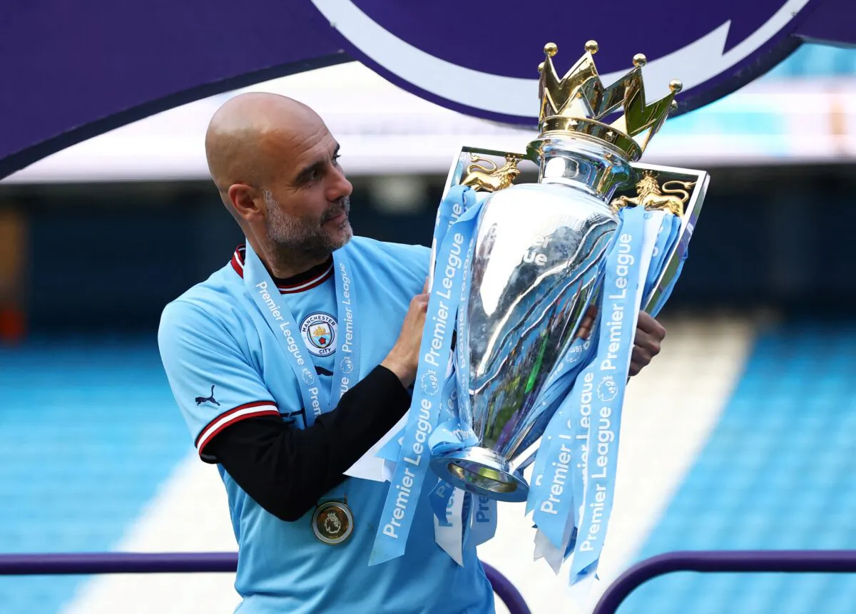 Manchester City manager Pep Guardiola poses with the trophy as he celebrates after winning the Premier League in Etihad Stadium, Manchester, Britain, on May 21, 2023. (Lee Smith/Reuters)