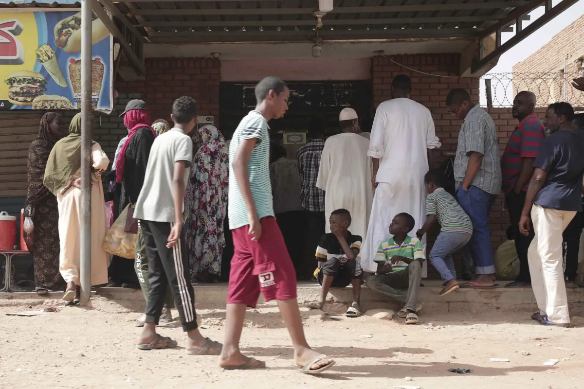People line up in front of a bakery during a cease-fire in Khartoum, Sudan, on May 27, 2023. (Marwan Ali/AP Photo)