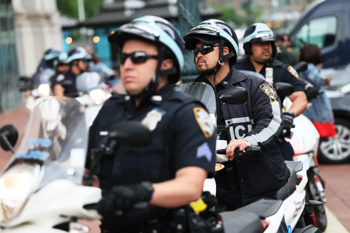 NYPD officers follow along as people participate in the Care Not Criminalization march in New York on May 24, 2023. (Michael M. Santiago/Getty Images)