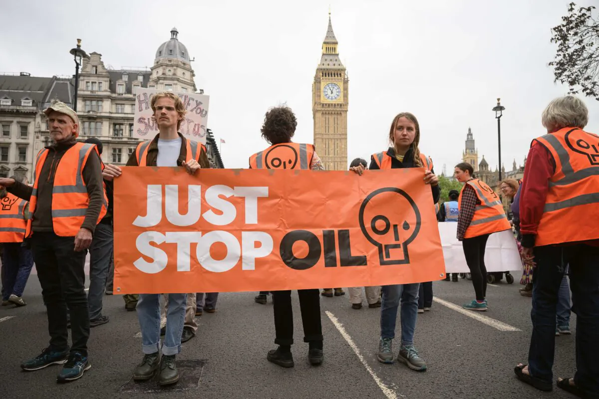 A group of environmental campaigners from the Just Stop Oil group block traffic as they take part in a slow procession around Parliament Square in London on May 31, 2023. (Leon Neal/Getty Images)
