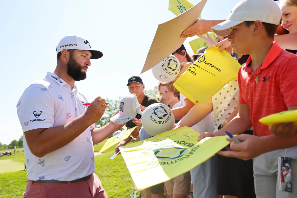 Jon Rahm of Spain signs autographs for fans after playing a practice round prior to the Memorial Tournament presented by Workday at Muirfield Village Golf Club in Dublin, Ohio, on May 31, 2023. (Michael Reaves/Getty Images)