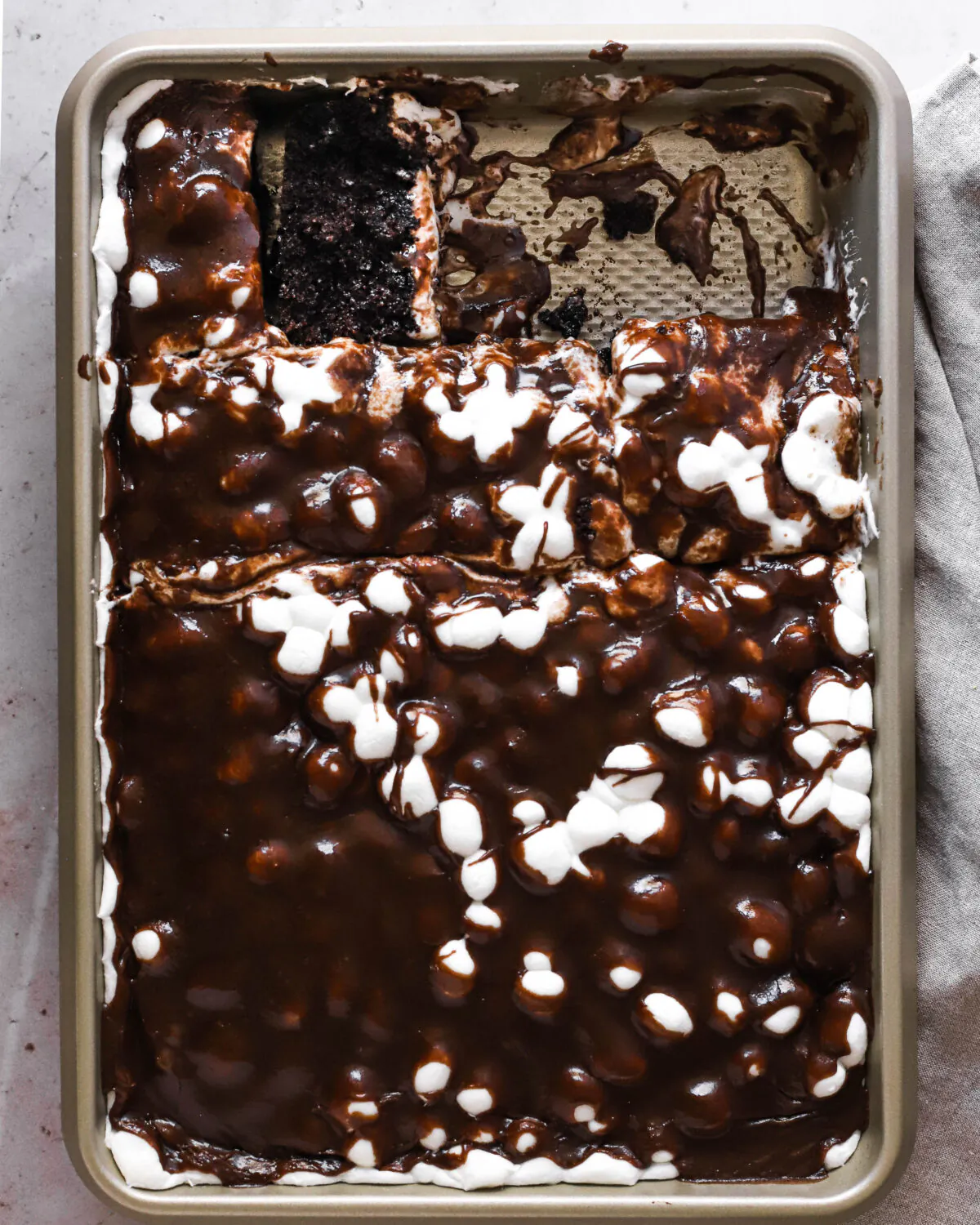 This tender chocolate cake is layered with gooey, melted marshmallows and warm chocolate frosting. (Maria Do/TNS)