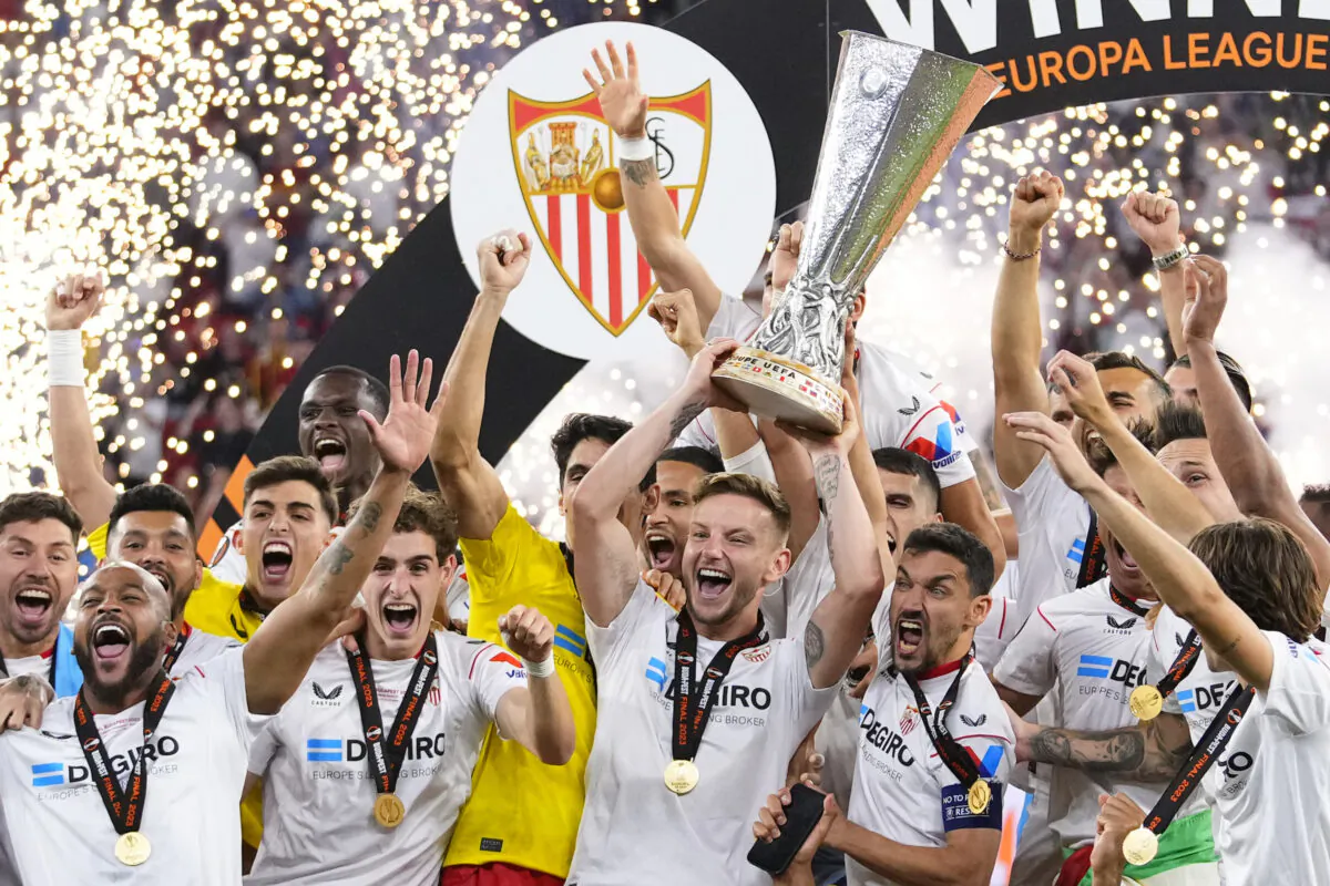 Sevilla's team captain Ivan Rakitic lifts the trophy after winning the Europa League final soccer match between Sevilla and Roma, at the Puskas Arena in Budapest, Hungary, on May 31, 2023. (Petr David Josek/AP Photo)