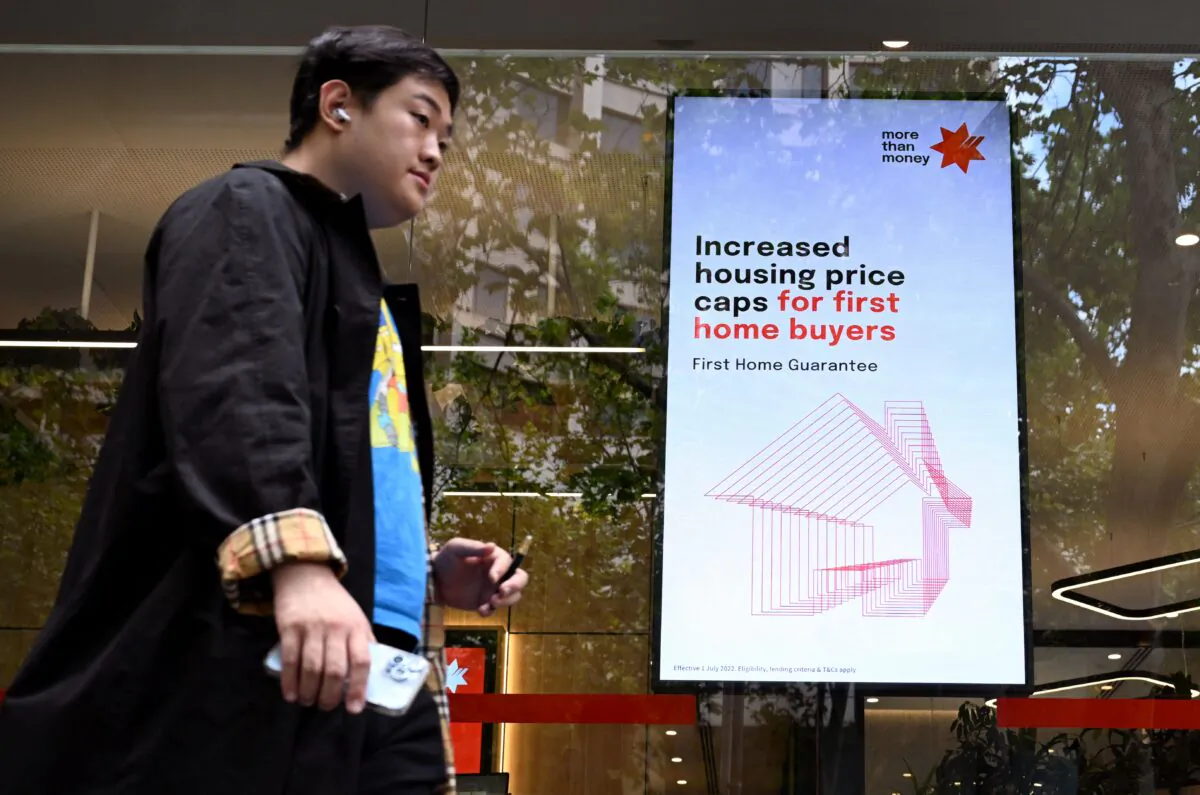 A man walks past a bank advertising home loans in Melbourne, Australia, on Feb. 7, 2023. (William West/AFP via Getty Images)