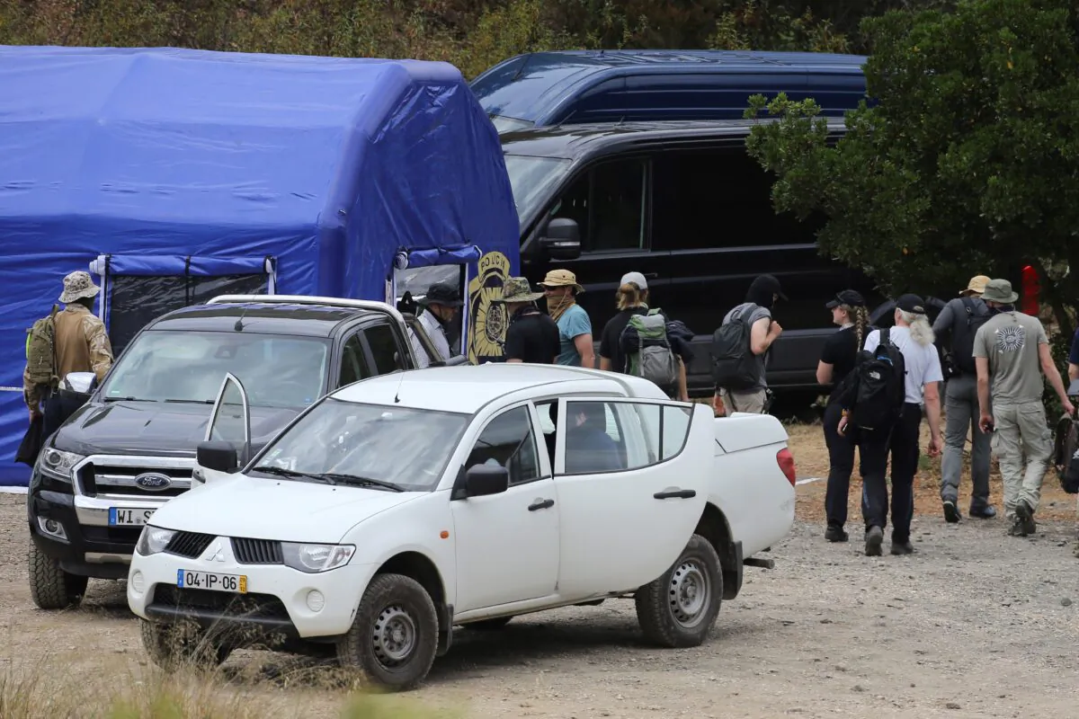 Police search teams arrive back to an operation tent near Barragem do Arade, Portugal, on May 23, 2023. (Joao Matos/AP Photo)