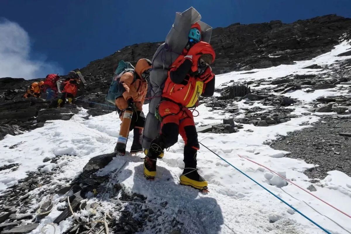 Ngima Tashi Sherpa walks as he carries a Malaysian climber while rescuing him from the death zone above camp four at Everest, Nepal, on May 18, 2023, in this screengrab obtained from a handout video. (Gelje Sherpa/Handout via Reuters)