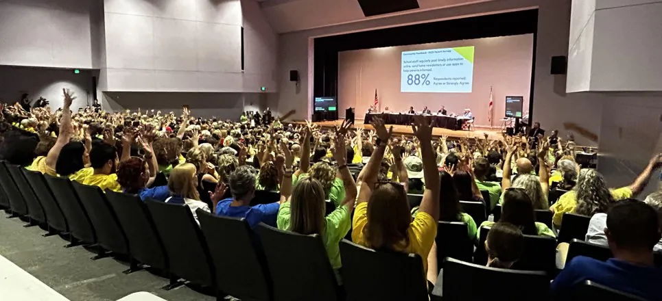 Attendees at a Hernando County School Board meeting in Hernando County, Fla., raise their hands in show of support for a speaker during public comments on May 30, 2023. (Patricia Tolson/The Epoch Times)
