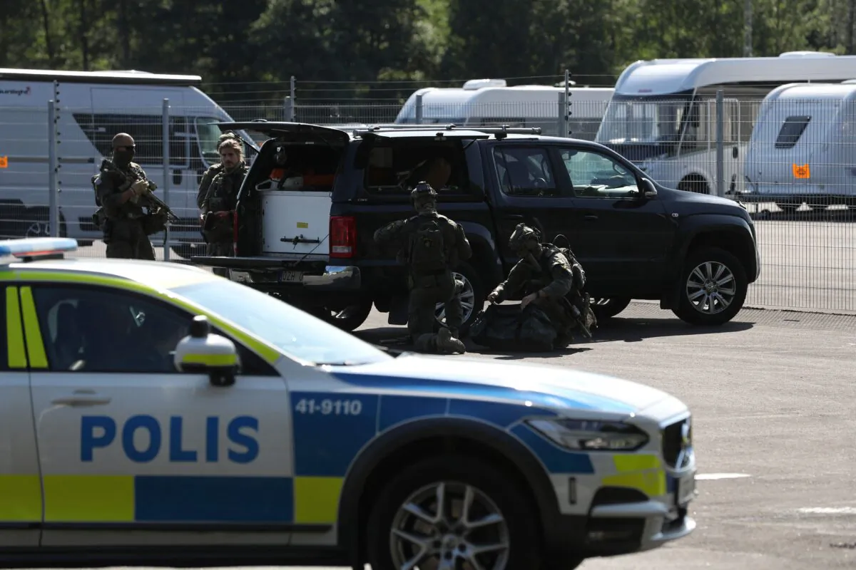 Special unit police forces are seen by a car near Eskilstuna in Sweden on July 21, 2021. (Karlsson Per/TT News Agency/AFP via Getty Images)