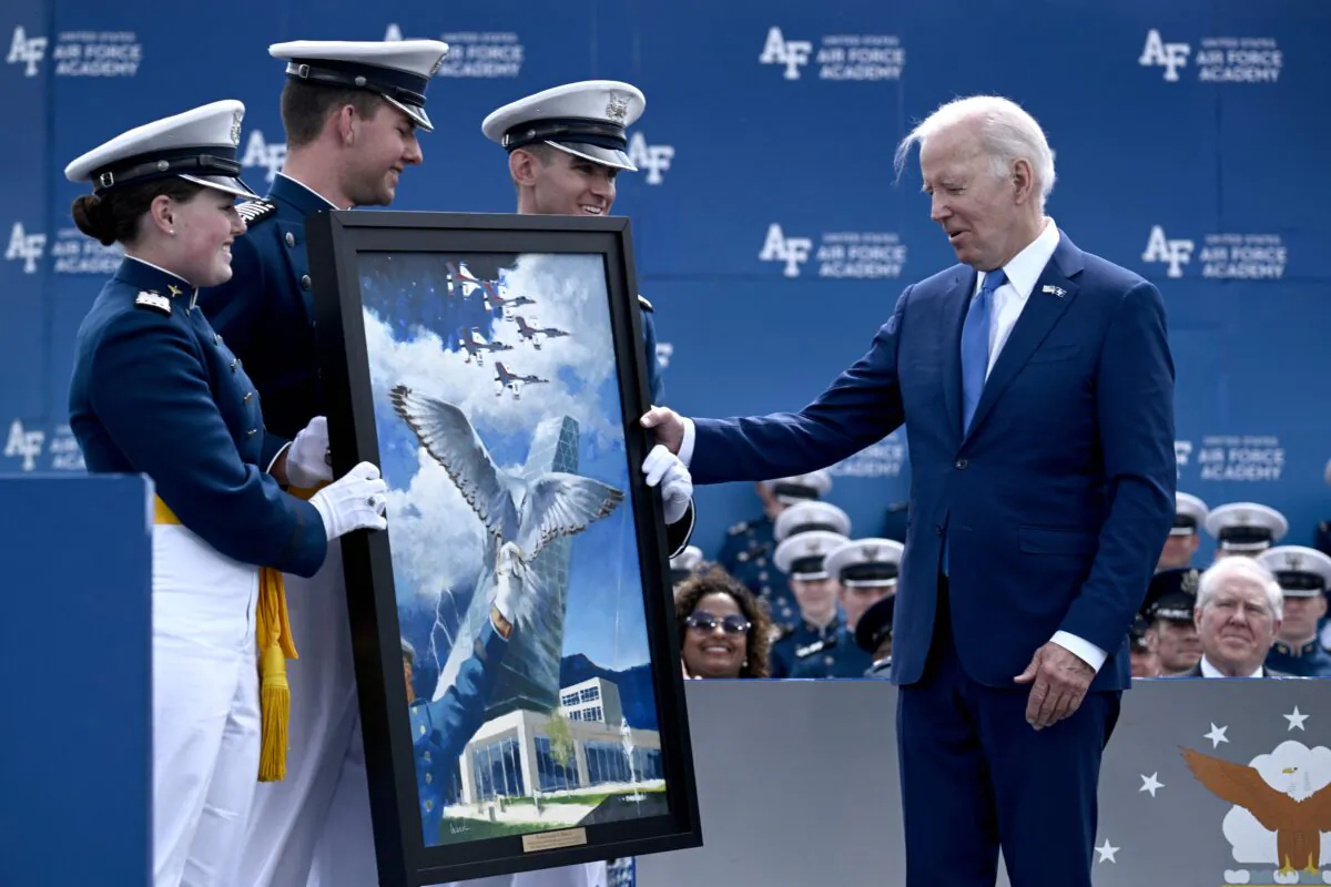 President Joe Biden looks at a framed piece of art prior to delivering the commencement address at the U.S. Air Force Academy, just north of Colorado Springs in El Paso County, Colo., on June 1, 2023. (Brendan Smialowski/AFP via Getty Images)