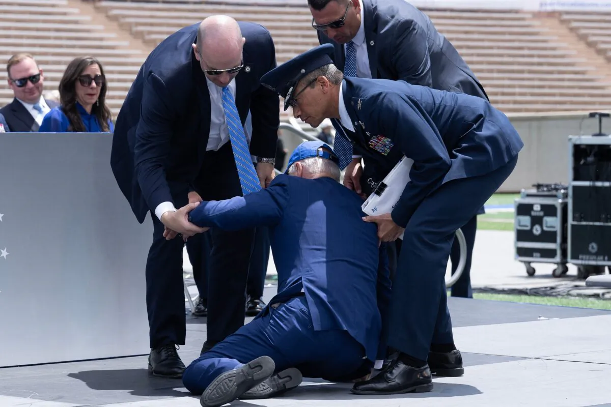 President Joe Biden is helped up after falling during the graduation ceremony at the U.S. Air Force Academy, near Colorado Springs in El Paso County, Colo., on June 1, 2023. (Brendan Smialowski/AFP via Getty Images)